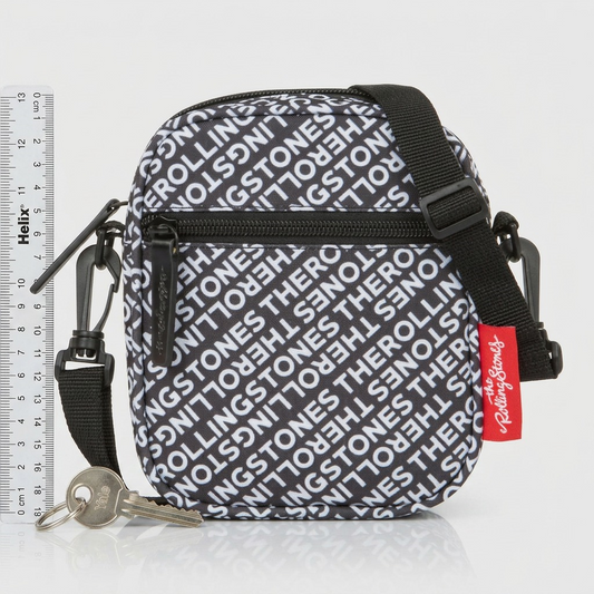 A small crossbody bag next to a ruler and set of keys to illustrate true scale.