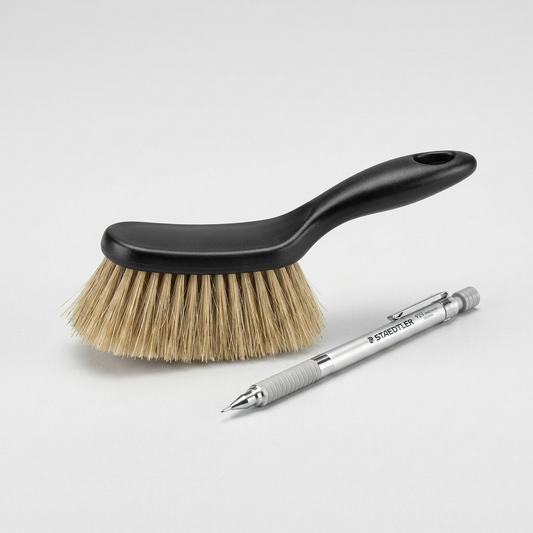 A compact STAEDTLER dusting brush mini is shown in a size comparison next to a standard length STAEDTLER mechanical pencil.