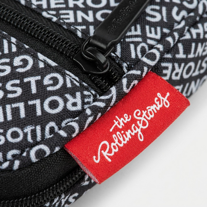 Macro shot of the side-seam red 'Rolling Stones' logo tag intersection with textured bag fabric.