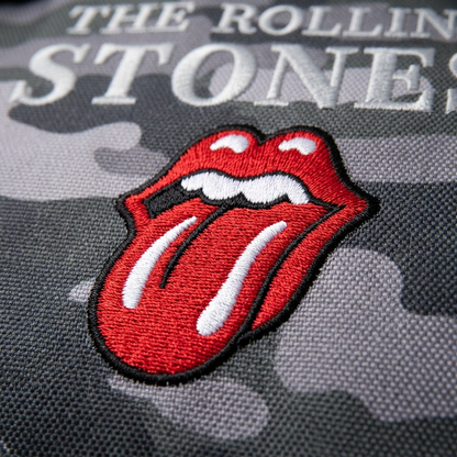 An extreme close-up view of the detailed embroidered red tongue logo and text on camouflage fabric.