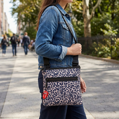 A woman wears a leopard print crossbody bag during a casual daytime walk, showcasing its features.