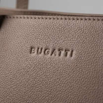 Extreme close-up of the pebbled taupe leather texture and debossed "BUGATTI" logo.