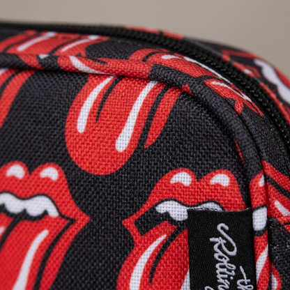 An extreme close-up of the Rolling Stones patterned fabric on the pencil case, showing polyester texture and clear stitching.