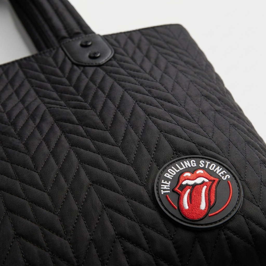 Extreme close-up of quilted nylon fabric texture and Rolling Stones patch on the Bugatti tote bag.