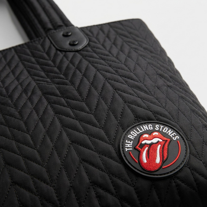 Extreme close-up of quilted nylon fabric texture and Rolling Stones patch on the Bugatti tote bag.