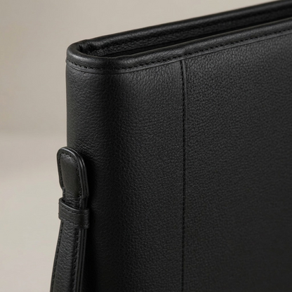Detailed macro photograph of the Bugatti leather ring binder craftsmanship, showing material texture and stitching.