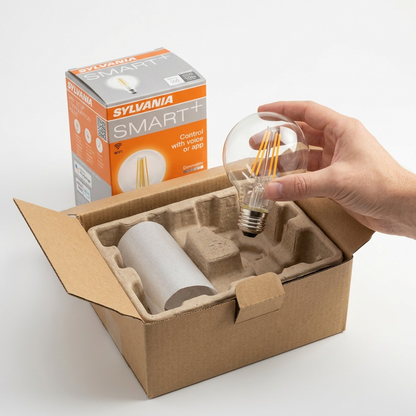 An e-commerce photo displays a Sylvania SMART+ G25 filament bulb inside a protective shipping carton.