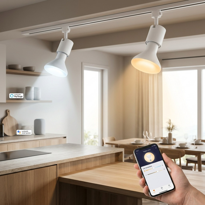 A kitchen and dining area with two SYLVANIA SMART+ WiFi Tunable White BR30 LED bulbs, one emitting cool light onto a counter, the other warm light on a table, all controlled via smartphone.