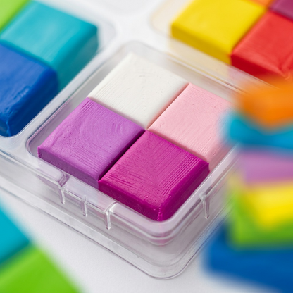 A detailed macro photograph showing the precise, smooth surface of four fused FIMO soft clay samples.