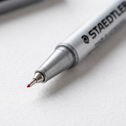 Macro detail of the metal fine-liner tip and legible 'STAEDTLER' barre printing.