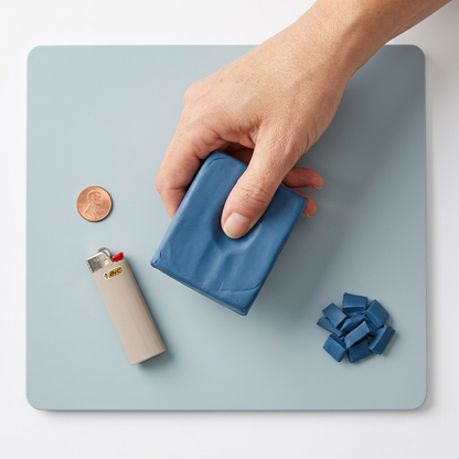 A real-world scale reference photo showing a hand holding the specified Staedtler Fimo Soft clay block.