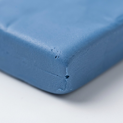 Macro detail shot focusing on the smooth, unbaked texture of Staedtler Fimo Soft Windsor Blue clay.