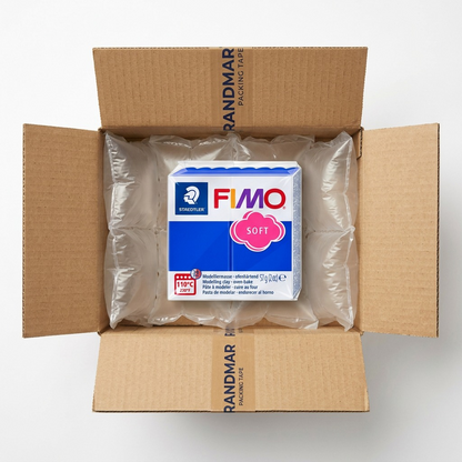 Premium ecommerce product photo of Fimo Soft blue clay block in its original clear film, secure within a heavy-duty cardboard shipping box with protective air pillows.