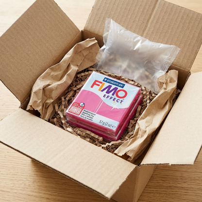 Close-up photo of Fimo Effect Ruby Quartz in a protective, neutral shipping box.