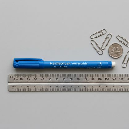 PDP Visual Matrix Image 2: A top-down view comparing a blue Staedtler correctable pen to a standard ruler and a paperclip.