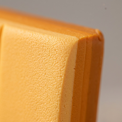 Extreme close-up of STAEDTLER Fimo Soft Mango Caramel clay, highlighting its soft texture.