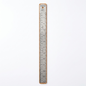 A premium, close-up photograph of the Staedtler Mars limited edition stainless steel ruler on a pure white background. The full length of the twelve-inch ruler is visible, showing the detailed imperial and metric measurements, the cork back, and the Staedtler branding at the top. The brushed metal texture is clear, and a subtle drop shadow grounds the object.