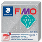 A high-resolution, centered view of a 57g (2 oz) block of grey glitter FIMO Effect oven-bake modelling clay (STAEDTLER, item 8020-812) on a white background, featuring realistic texture and markings.