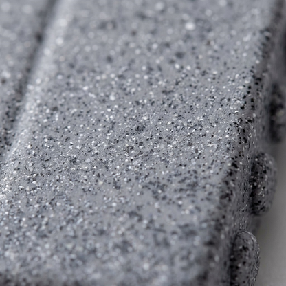 A macro photograph detailing the speckles and fine texture of the FIMO granite clay material.