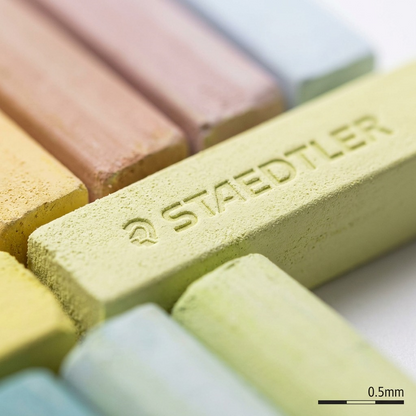 Macro phot of a single yellow Staedtler soft pastel stick, showing its fine chalk texture, faceted sides, and crisp logo stamp.