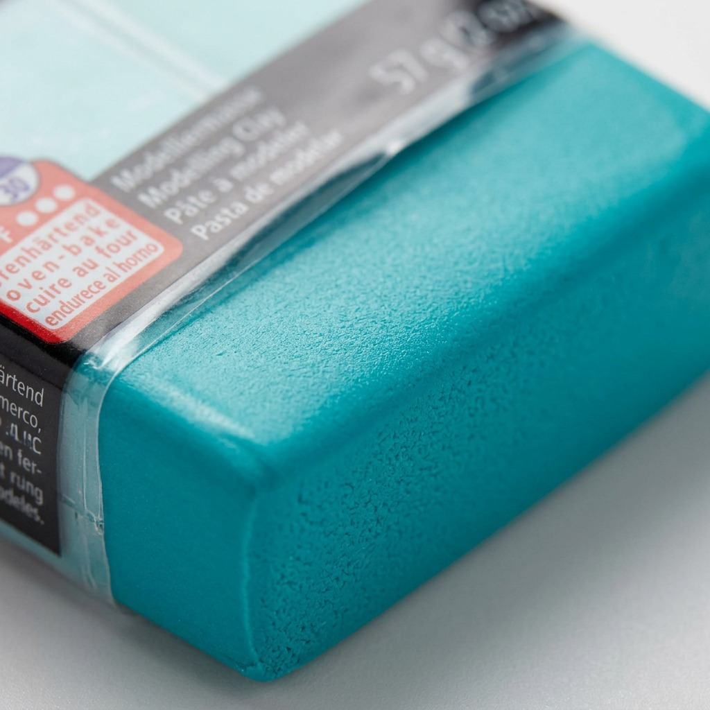 A macro detailed view showcasing the fine texture and consistency of the turquoise polymer clay.