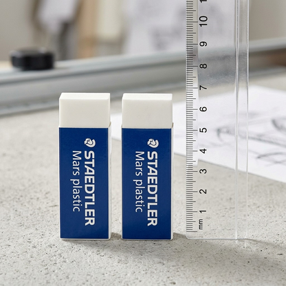 A scale reference image showing two Staedtler Mars plastic erasers next to a clear ruler.