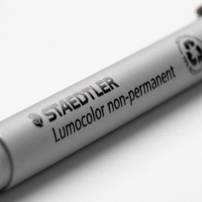 Extreme macro view of the barrel of the STAEDTLER Lumocolor non-permanent marker (image_0.png) focusing on the print details.