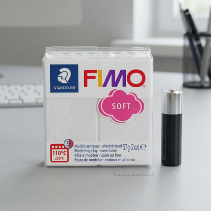 An image showing a STAEDTLER Fimo Soft modelling clay package next to a standard AA battery.