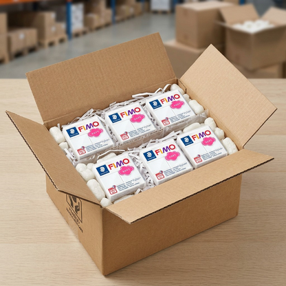 A realistic photo of multiple blocks of STAEDTLER Fimo Soft White clay securely packed and protected for shipping within a sturdily cushioned, open-air corrugated carton, demonstrating arrival confidence.