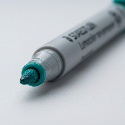 Extreme macro view captures the specific 'F' (Fine) tip shape and blue-green ink flow of the Staedtler marker.
