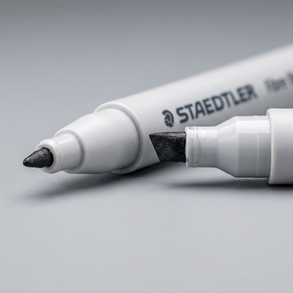 Macro close-up shot of a single marker barrel showing finely printed manufacturer logo and barrel markings.