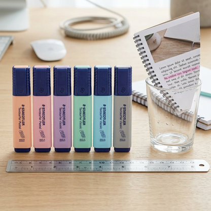 Scale comparison image shows the STAEDTLER Textsurfer Pastel set near an open notebook on a desk.