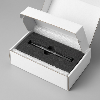 A Staedtler 313 permanent marker arriving in a clean cardboard shipping box filled with protective foam padding.