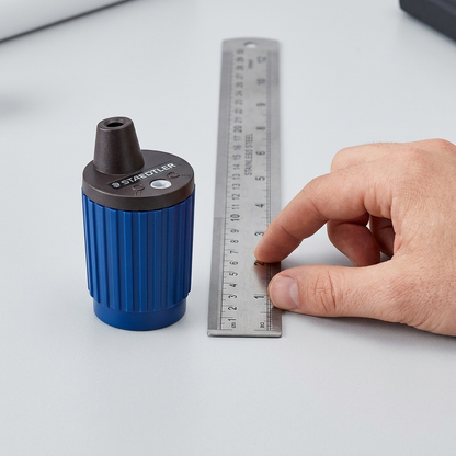 A STAEDTLER Mars 2mm lead pointer beside a ruler and hand for accurate scale reference.