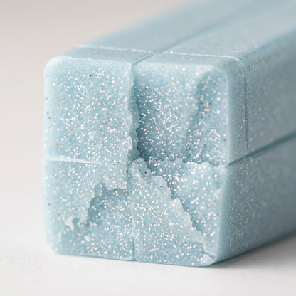 A macro photograph showing the internal mica particles within the semi-translucent Fimo Effect Blue Ice Quartz clay block.