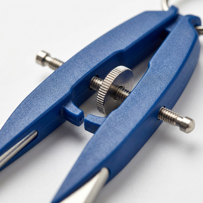 An extreme close-up photograph focuses on the central screw mechanism of the Staedtler Mars 556 comfort compass, showing the intricate thread and the textured metal wheel.