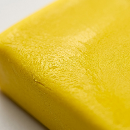 Macro photography shows the fine grain texture and consistency of the yellow Fimo Professional clay.