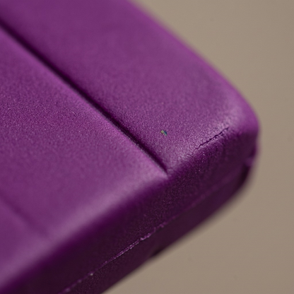 Macro photograph showing the smooth, dense texture and clean score line of Fimo Professional Violet clay.