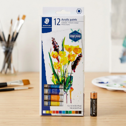 An image showing the STAEDTLER acrylic paint set box next to a standard AA battery for scale.