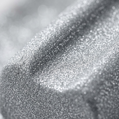 An intense close-up photographing the sparkling texture of the silver glitter Fimo Effect clay.