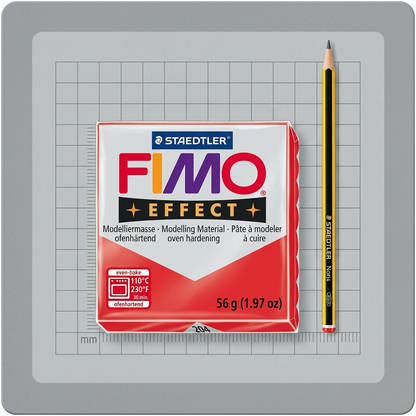 A photo of a STAEDTLER Fimo Effect Red block with a standard pencil next to it for scale.