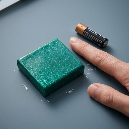 A studio photograph shows an 8010-562 Fimo Effect clay block next to a standard AA battery and a human index finger.