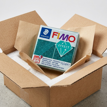 Premium ecommerce product photo (image 7) of unboxing an intact STAEDTLER Fimo Effect Galaxy Green block from protective transit.