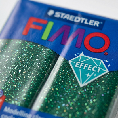 Extreme macro view of the Fimo clay's glittering texture, labels, and shiny film wrap.