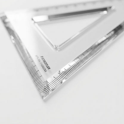 Macro photograph of the clear acrylic set square edge, showing beveled geometry and clean cut.