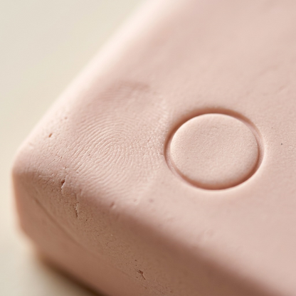 Extreme macro shot of the FIMO Soft Pale Pink clay texture with fingerprint detail.