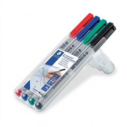 A premium, close-up photo of the STAEDTLER Lumocolor non-permanent fineliner markers. The four-pack includes black, blue, red, and green markers, aligned and parallel, with the brand and type text clearly visible on their silver barrels. The setting is a clean, crisp product shot ready for ecommerce.