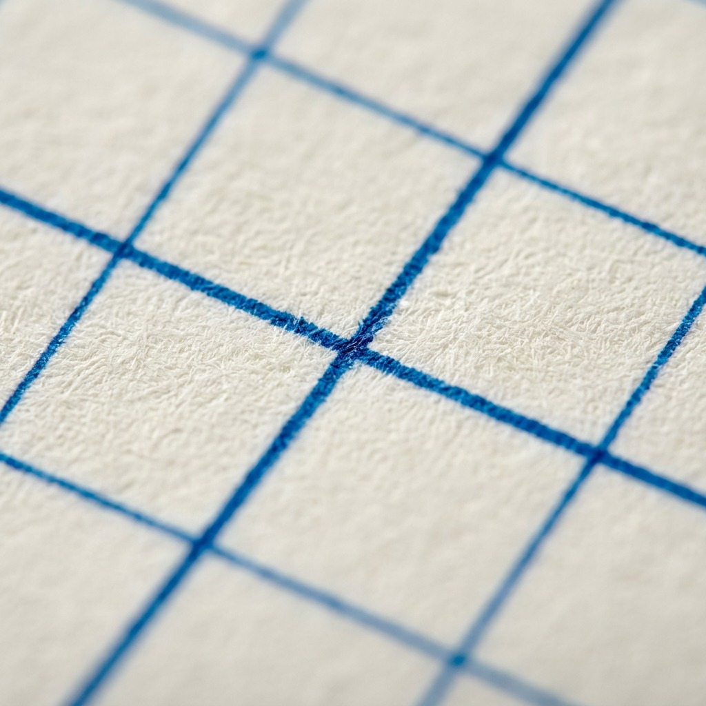 A macro photo of the Staedtler graph paper notepad, highlighting the distinct blue grid pattern on a single page.