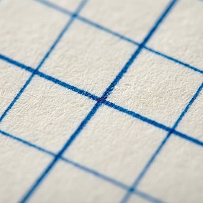 A macro photo of the Staedtler graph paper notepad, highlighting the distinct blue grid pattern on a single page.