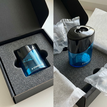 Scene showing the Staedtler oval sharpener unboxed from protective foam and a secure shipping box.